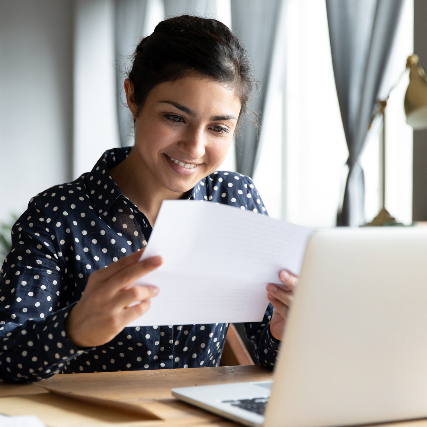 Woman smiling while reading document